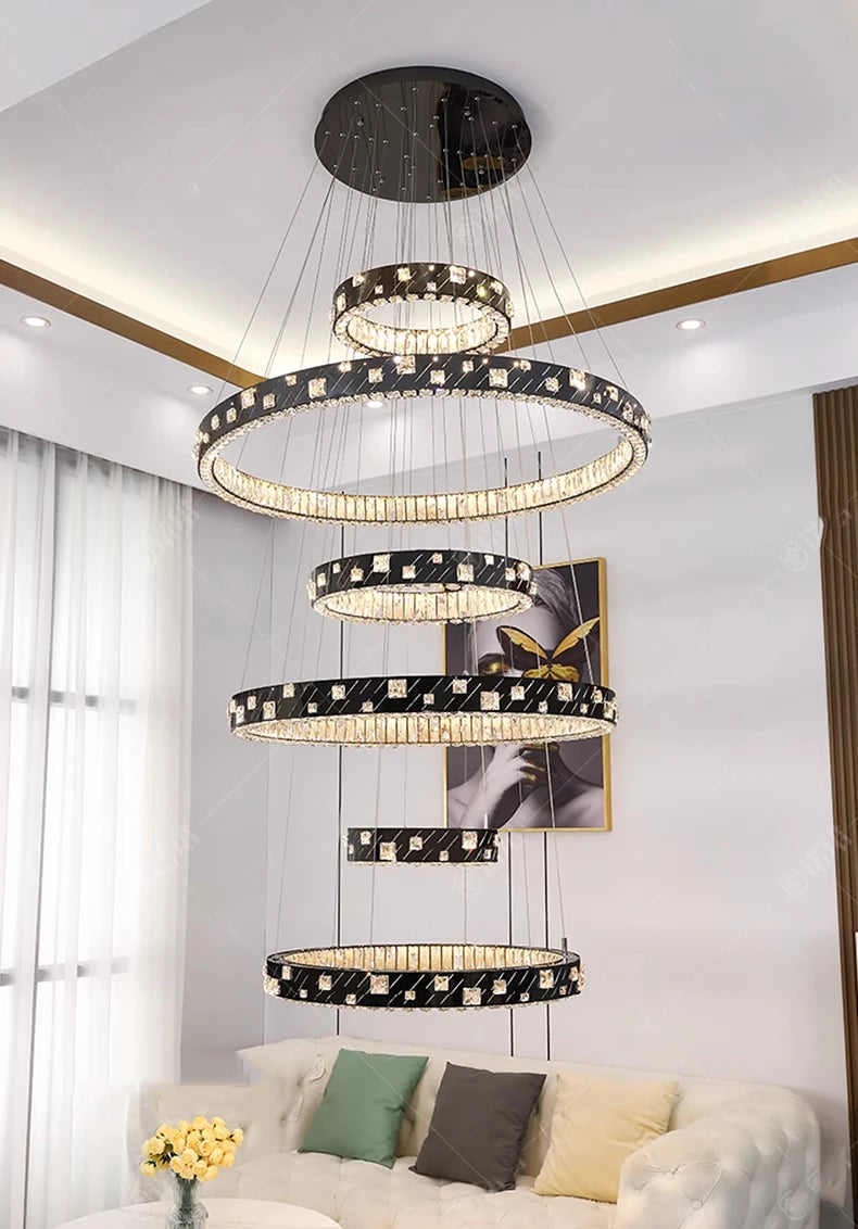 Modern chandelier hanging in a living room with a sofa and decor.