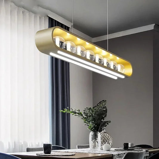 Modern gold oval frame pendant light with multiple clear glass globes and integrated LED strip lighting hanging above a dining table.