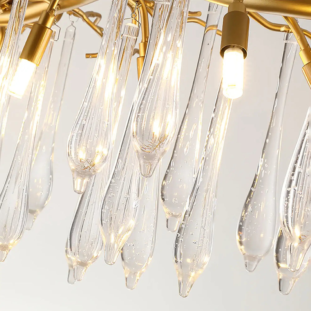Close-up of a chandelier with clear glass lampshades and gold fixtures.