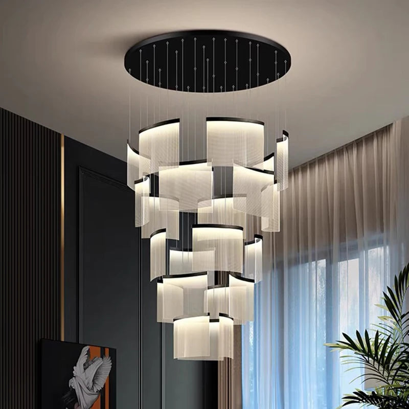 Modern chandelier hanging in a room with a window and plant