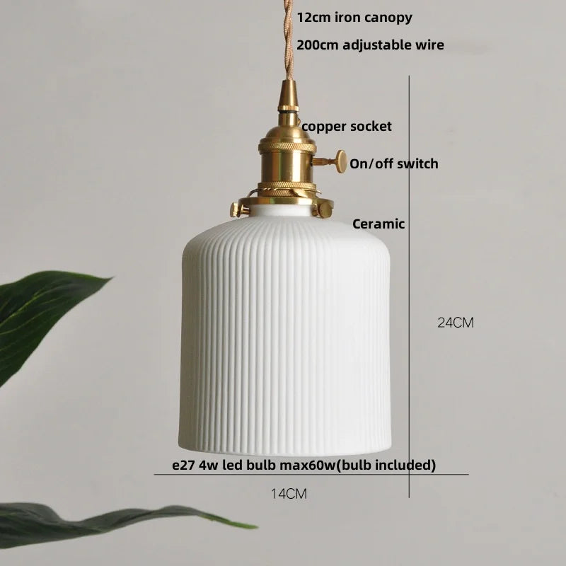 White ceramic pendant light with gold fixture and measurements on a gray background