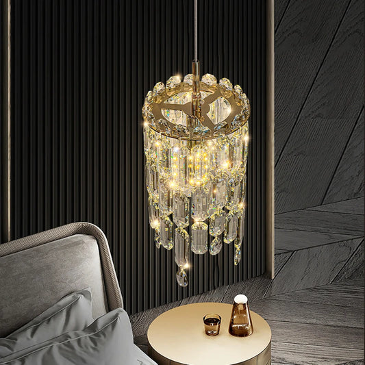 Close-up of a gold tiered crystal pendant light with hanging prisms