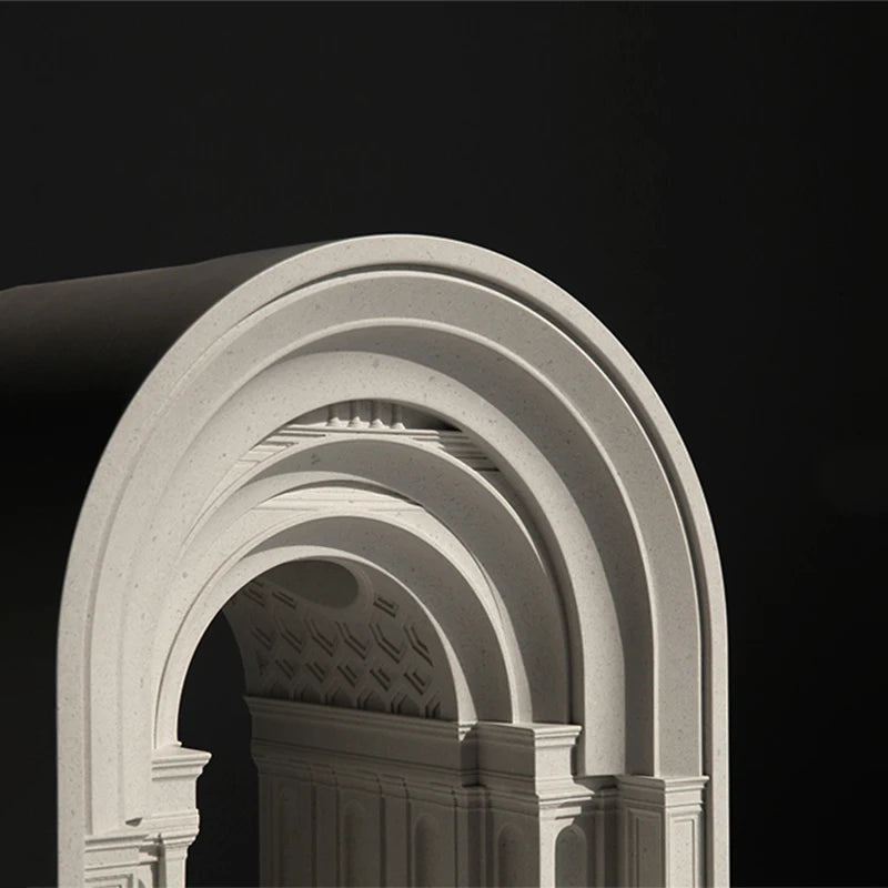 Architectural detail of a stone archway with decorative elements on a black background