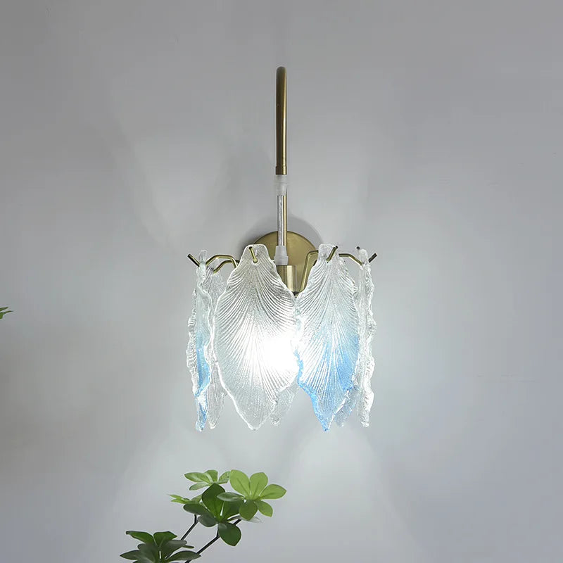 Decorative wall light fixture with glass shades on a plain background