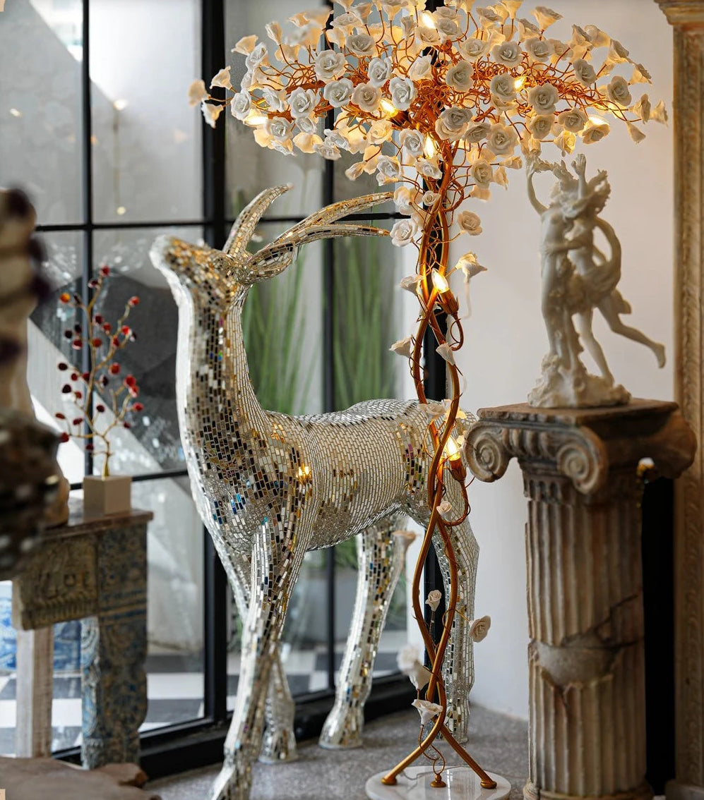 Decorative lamp with deer sculpture and mirror in a room setting