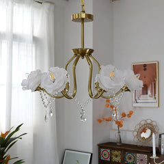 White rose lampshades on a gold chandelier with crystal pendants, displayed in a well-lit room setting.