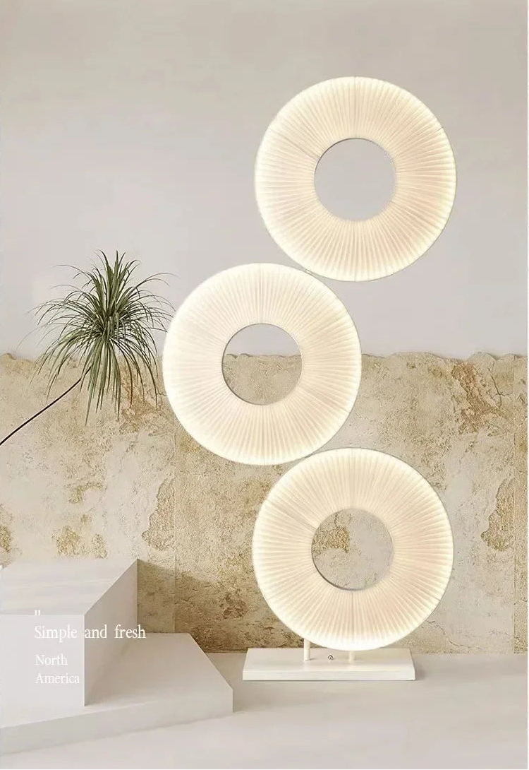 Decorative lamp with three circular designs on a neutral background