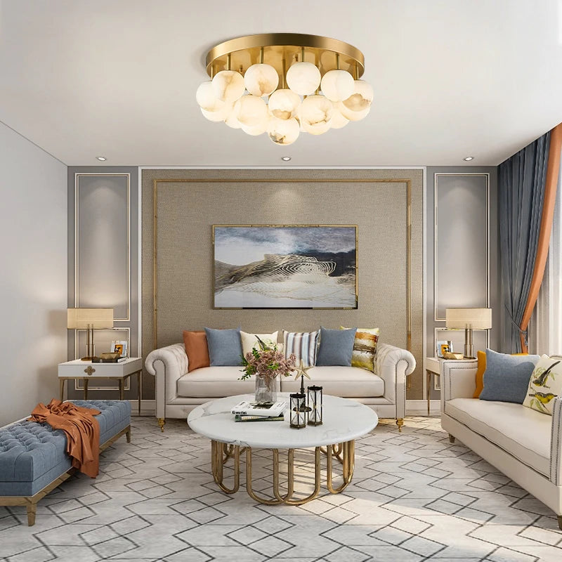 A bright living room featuring a gold flush mount ceiling light with a cluster of marble-effect globes.