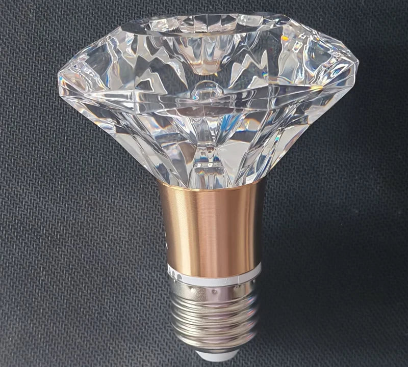 Crystal light bulb with a diamond-shaped design on a dark background