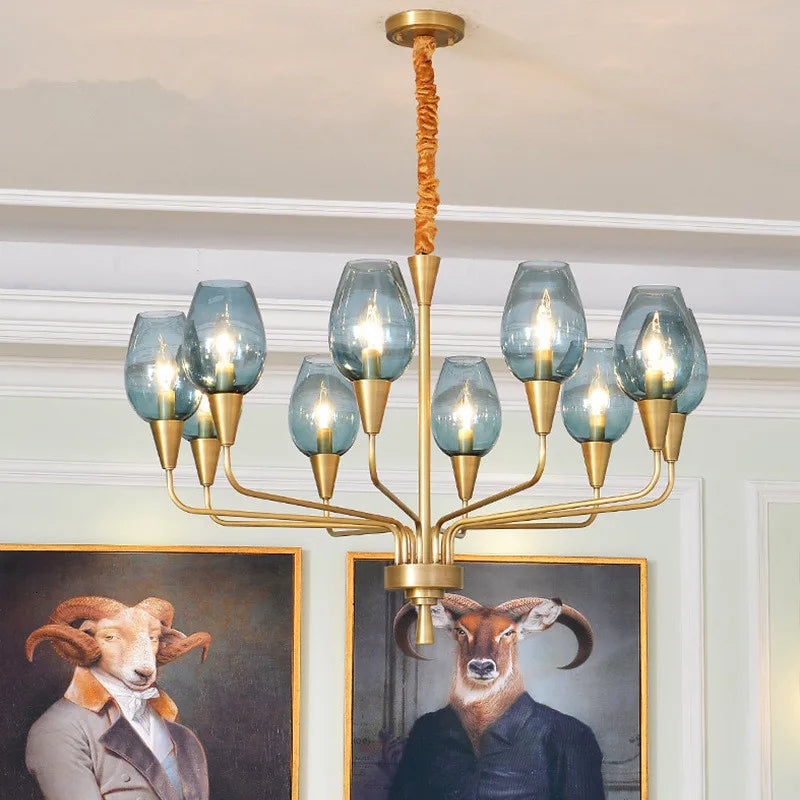 Gold chandelier with blue glass shades and artwork featuring anthropomorphic animals in the background.