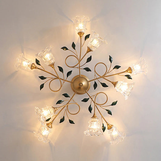 Overhead view of a gold floral semi-flush ceiling light with multiple clear glass shades arranged in a starburst pattern.