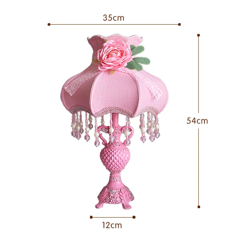 Pink decorative lamp with floral design and measurements on a white background