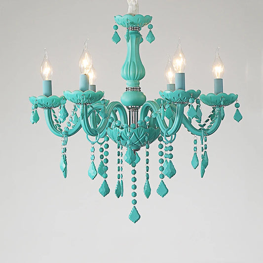 Close-up of a cyan crystal chandelier with six flame-shaped LED bulbs and intricate crystal detailing, against a white background.
