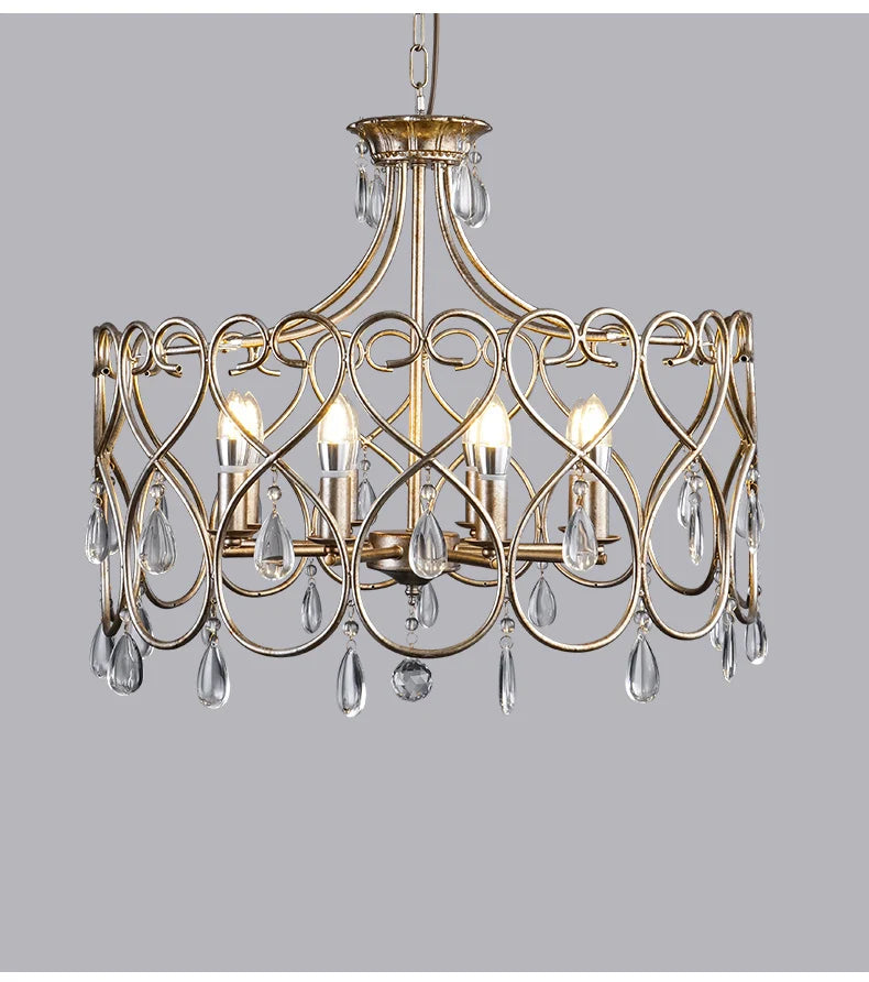 Gold chandelier with crystal accents on a gray background