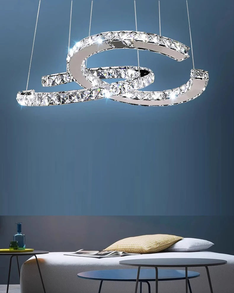 Modern chandelier with crystal accents hanging above a living room.