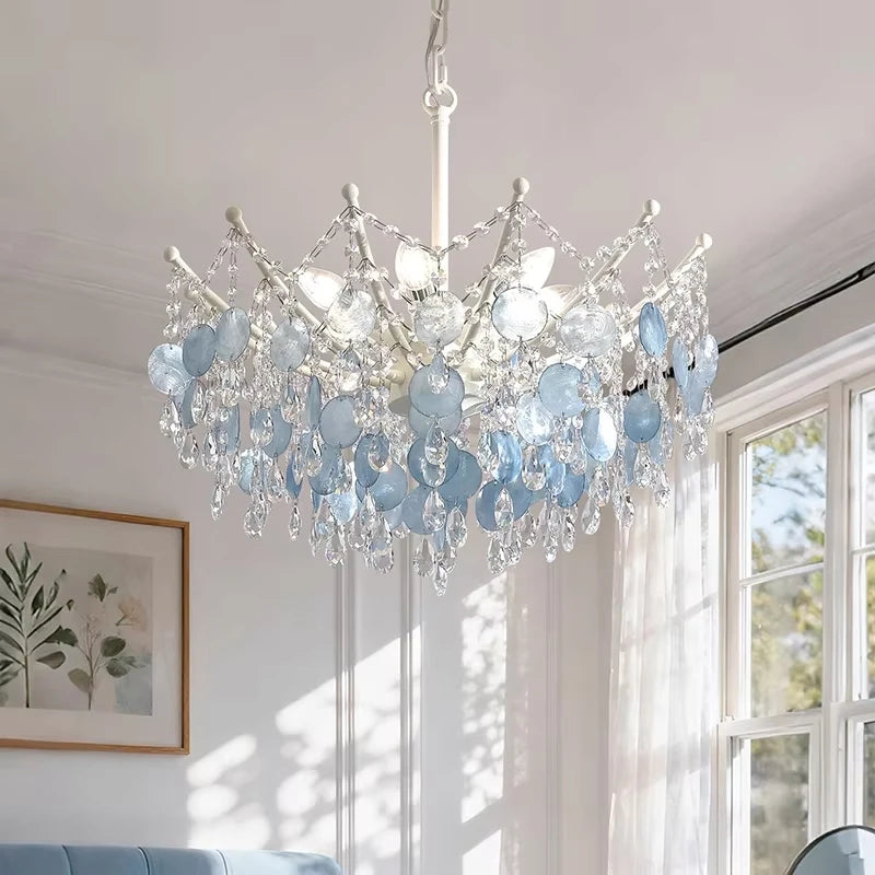 Side profile of the gold crystal chandelier, highlighting its layered structure and the warm glow of its integrated LED lights.