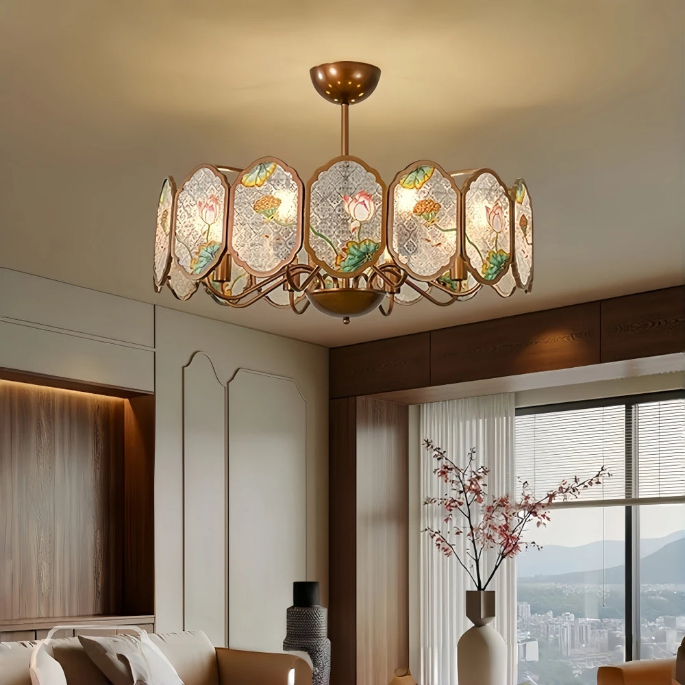 Copper frame chandelier with oval acrylic panels featuring lotus floral designs, illuminating a living room.