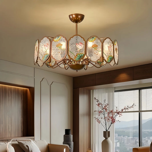 Copper frame chandelier with oval acrylic panels featuring lotus floral designs, illuminating a living room.