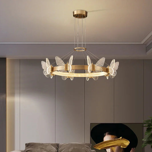 Close-up of the gold butterfly and clear crystal details on the ring pendant light.