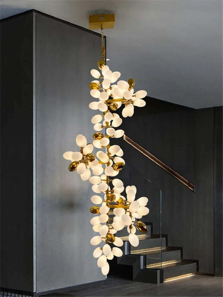 Decorative chandelier hanging in a modern interior setting with stairs.