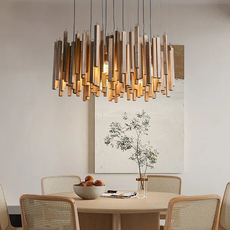 Close-up of a wooden stick chandelier with neutral light, hanging over a round table