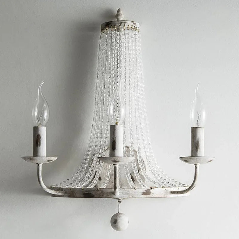 Silver chandelier with crystal accents on a plain background
