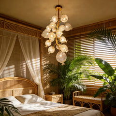 Gold floral chandelier with crystal accents in a bedroom setting.