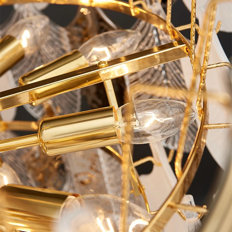 Close-up of a gold chandelier with clear glass shades.