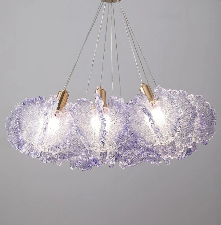 Chandelier with purple glass shades and gold accents on a gray background