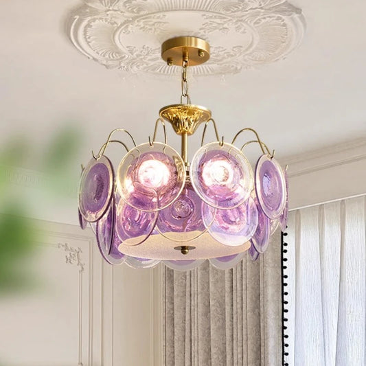 Gold semi-flush mount chandelier with purple glass discs and a decorative ceiling medallion