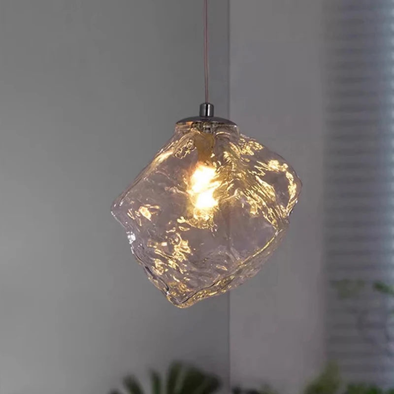 Glass pendant light with a textured design on a neutral background