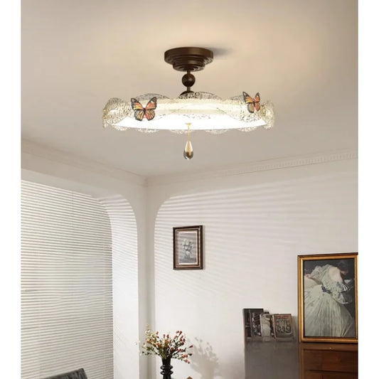 Close-up of the bronze butterfly and crystal details on the drum semi-flush ceiling light.