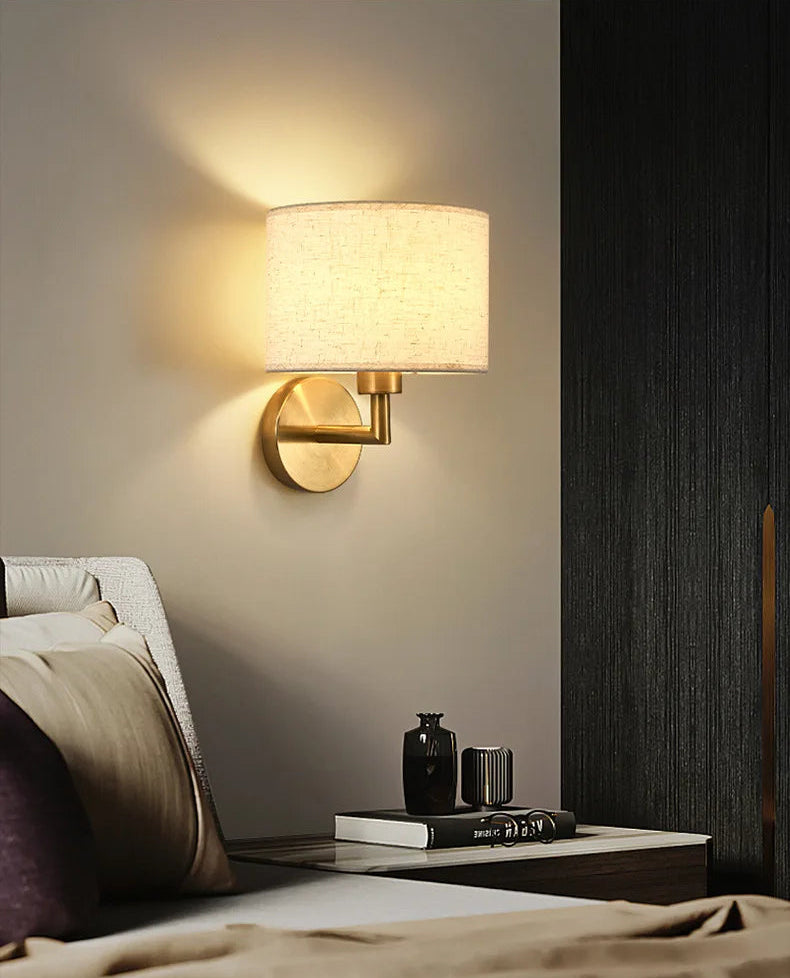 Wall-mounted lamp in a bedroom setting with a cozy ambiance