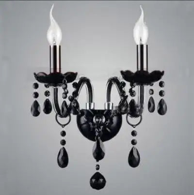 Black chandelier with crystal accents on a gray background