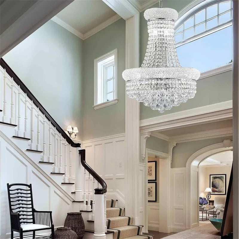 Luxurious staircase with a crystal chandelier in a home interior.