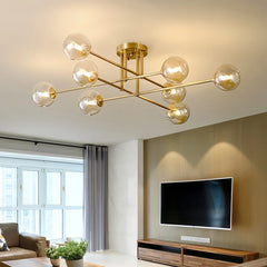 Gold sputnik starburst semi-flush ceiling light installed in a modern living room above a television