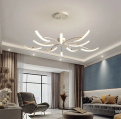 White chandelier with curved arms and LED lights in a bright living room setting.