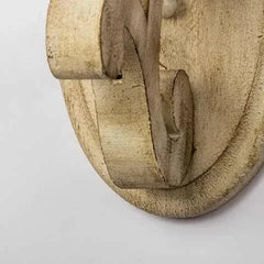 Close-up detail of the distressed wood texture and craftsmanship on the arm of the wall sconce.