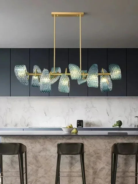 Modern kitchen with a gold chandelier and dark cabinets