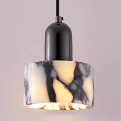 Detailed view of a marble pendant light with a black cap and frosted glass bottom, illuminated from within.