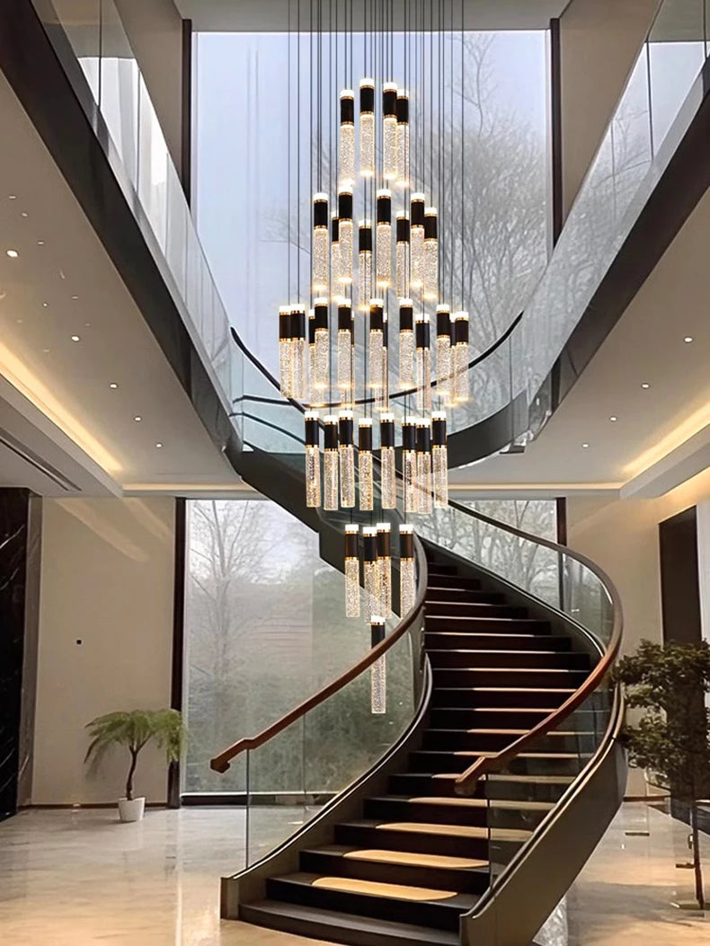 Luxurious staircase with a large chandelier in a modern building