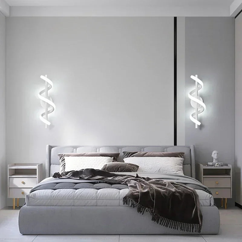Modern bedroom with gray bed, nightstands, and wall lights.