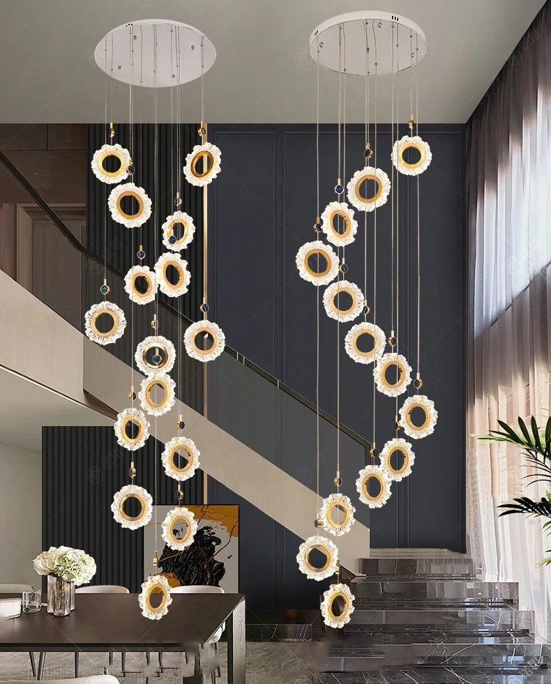 Decorative chandelier hanging in a modern interior setting with a staircase.