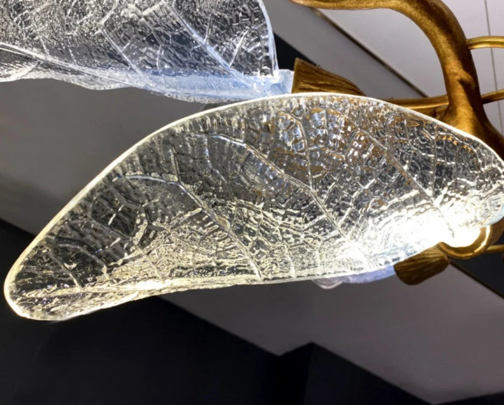 Decorative wall light with leaf design and gold accents.