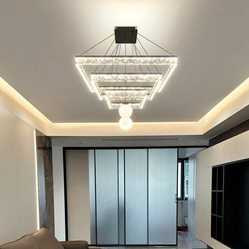 Modern chandelier hanging from a ceiling in a well-lit room.