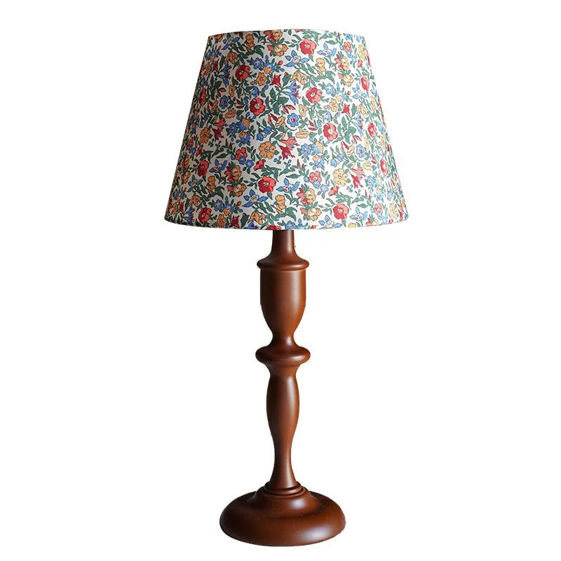 Table lamp with a floral patterned shade on a white background