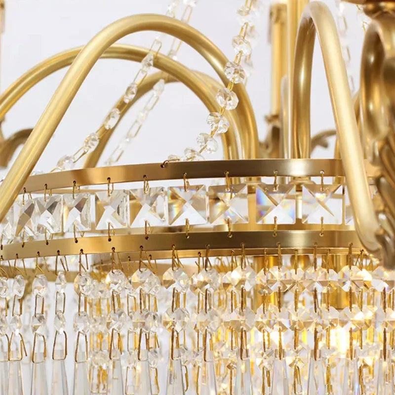 Detailed view of the tiered brass frame and crystal strands of the chandelier.