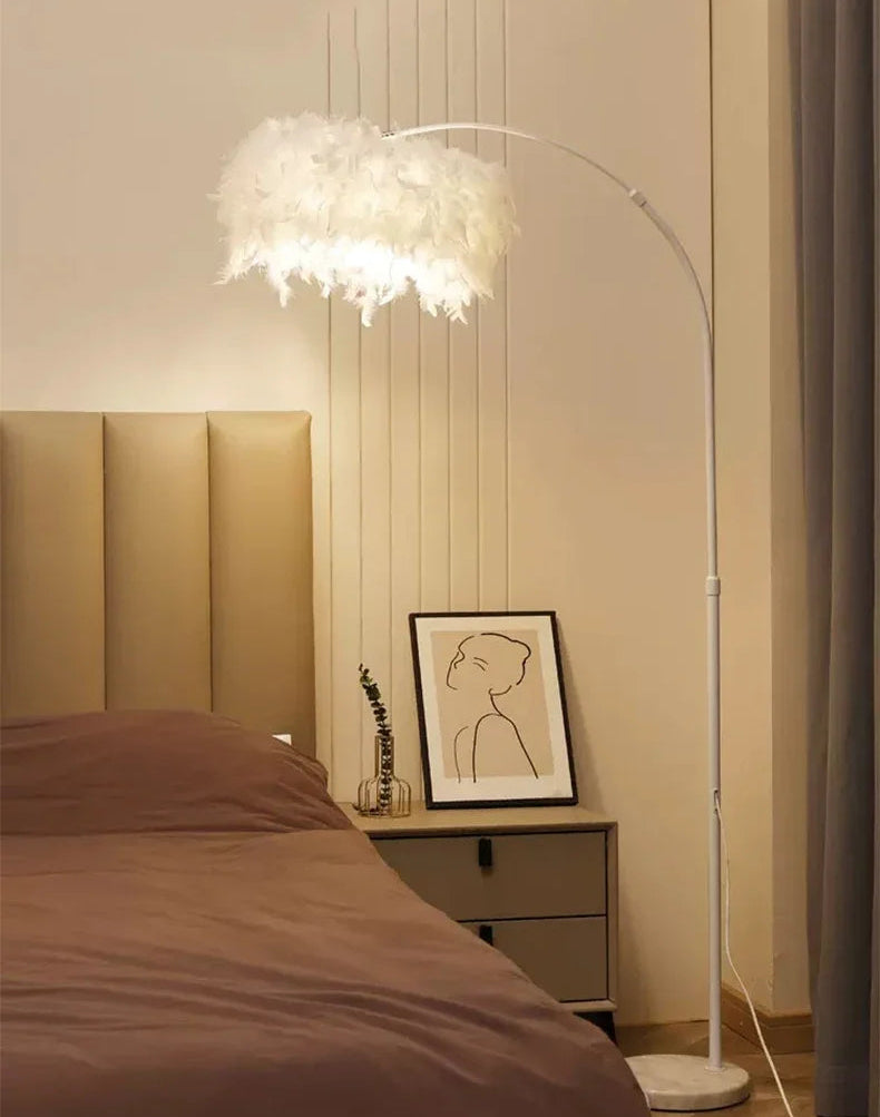 Modern bedroom with a standing lamp, bed, and wall art.