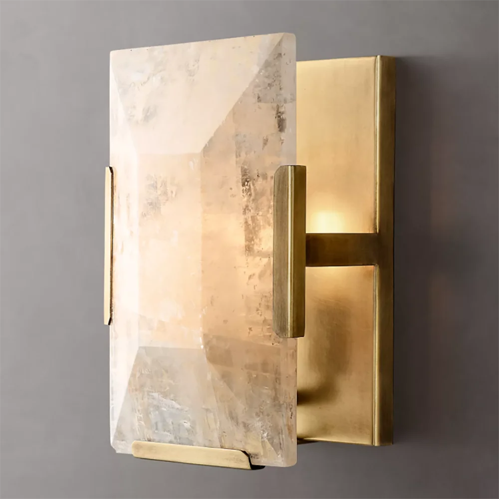 Modern wall sconce with marble and brass finish on a gray background