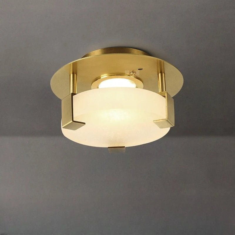 Gold geometric flush mount ceiling light with frosted glass diffuser and crystal accents, viewed from below.